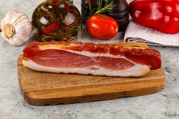 Piece prosciutto crudo over board