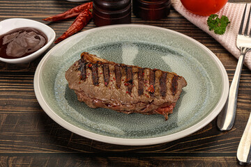 Grilled beef striploin steak with sauce