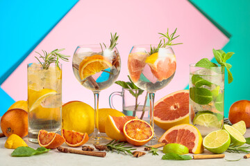 Refreshing summer cocktails with ingredients on a bright colorful background.