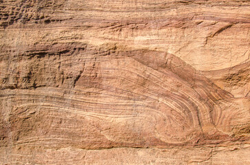 Red sandstone rock, natural tones, create mesmerizing texture and patterns, creating a natural earthy backdrop. 