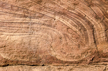 Red sandstone rock, natural tones, create mesmerizing texture and patterns, creating a natural earthy backdrop. 