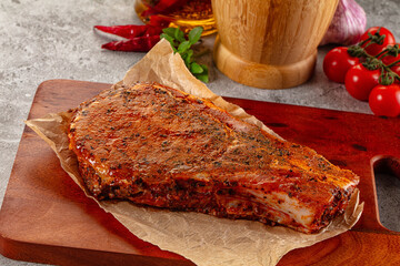 Raw marinated pork loin steak