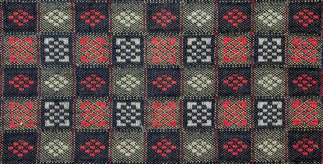 Intricate fabric pattern showcasing a striking grid of colorful squares, perfect for backgrounds.