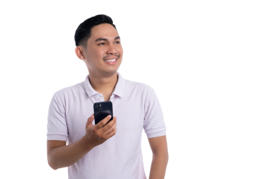 Smiling young man holding smartphone while looking away with happy expression isolated on transparent background