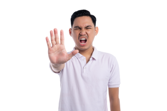 Angry young man showing stop hand gesture with serious facial expression isolated on transparent background