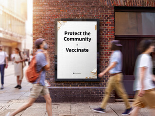 Urban vaccination awareness poster on city brick wall with protect community message and walking blur, Selective Focus..