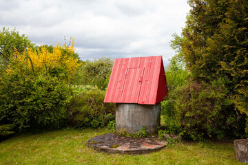 A traditional Lithuanian rural well, drawing water from underground springs. Concrete rings are sunk into the earth, where a spring fills the well with clean, fresh water.