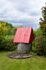 A traditional Lithuanian rural well, drawing water from underground springs. Concrete rings are sunk into the earth, where a spring fills the well with clean, fresh water.