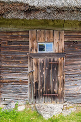 Door on a agricultural building built with wooden logs