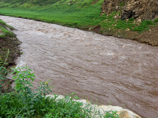 After heavy rain, the flood water from the highlands flows into the river. The water is muddy and has lots of wood chips and other things.
