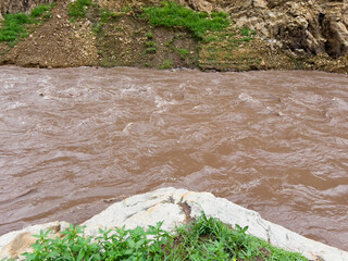 After heavy rain, the flood water from the highlands flows into the river. The water is muddy and has lots of wood chips and other things.
