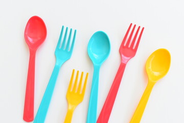 colorful spoon and fork isolated on white background, plastic cutlery for picnic