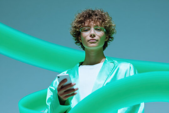 Stylish person using smartphone with futuristic green neon lights