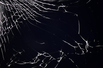 Cracked glass texture on black background. Isolated realistic cracked glass effect.
