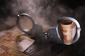 Handcuffs behind, five thousand rubles. Concept of corruption