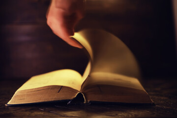 Book on a wooden table background with copy space. Historical atmosphere. Vintage english style....