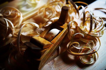 Hand planer with wooden sawdust. On a wooden background. High quality photo