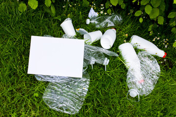 Plastic bottles and trash on grass highlighting environmental pollution