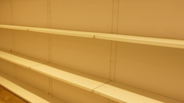 Empty shelves in a store create a sense of scarcity
