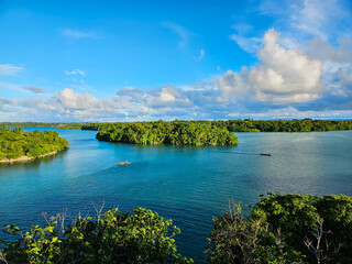 Photo of tropical islands and turquoise waters under a cloudy sky