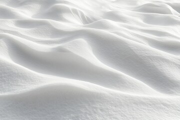 Close-up view of smooth, gently undulating snow surface with soft shadows creating a peaceful and serene winter texture