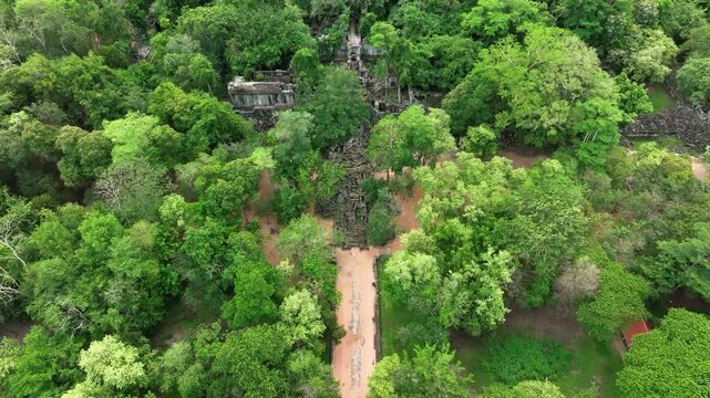Aerial dolly view, Beng Mealea temple ruins hidden in dense jungle