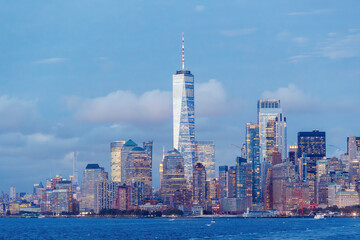 A vibrant sunset panorama of Manhattan downtown skyline, viewed from the river