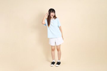 20s Asian Woman in Light Blue Shirt and White Shorts