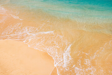 Sunny beach in Hawaii with golden sand and clear blue water