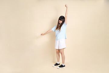 20s Asian Woman in Light Blue Shirt and White Shorts