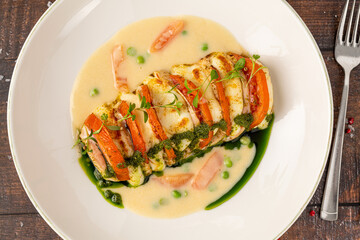 Stuffed chicken breast with tomato, mozzarella, cream and herb sauce