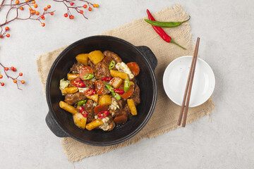  Jjimdak is a dish made by simmering chicken pieces with carrots, potatoes, garlic, peppers, green onions, onions, and glass noodles, and seasoning it with soy sauce or red pepper paste.