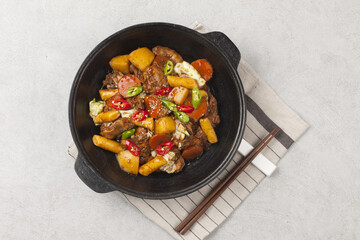  Jjimdak is a dish made by simmering chicken pieces with carrots, potatoes, garlic, peppers, green onions, onions, and glass noodles, and seasoning it with soy sauce or red pepper paste.