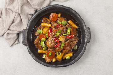  Jjimdak is a dish made by simmering chicken pieces with carrots, potatoes, garlic, peppers, green onions, onions, and glass noodles, and seasoning it with soy sauce or red pepper paste.