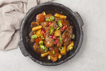  Jjimdak is a dish made by simmering chicken pieces with carrots, potatoes, garlic, peppers, green onions, onions, and glass noodles, and seasoning it with soy sauce or red pepper paste.