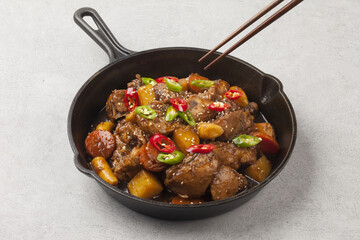  Jjimdak is a dish made by simmering chicken pieces with carrots, potatoes, garlic, peppers, green onions, onions, and glass noodles, and seasoning it with soy sauce or red pepper paste.