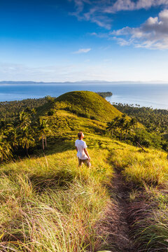 Man enjoying the sunrise near the coast, Albay province, Philippines