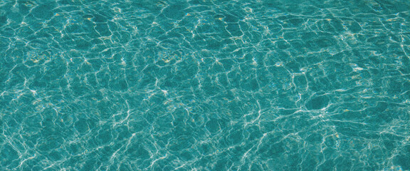 Turquoise and blurry sea waves. Grainy background.