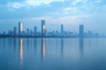 Obraz premium Calm city skyline at dawn with tall buildings reflecting golden sunlight on smooth water under a cloudy blue sky