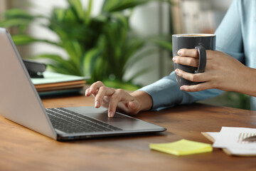 Woman hand working online on wooden table