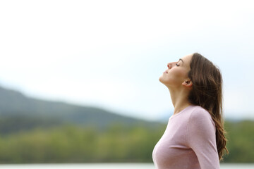 Woman in nature is breathing fresh air alone