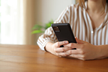 Woman hands texting on mobile phone at home