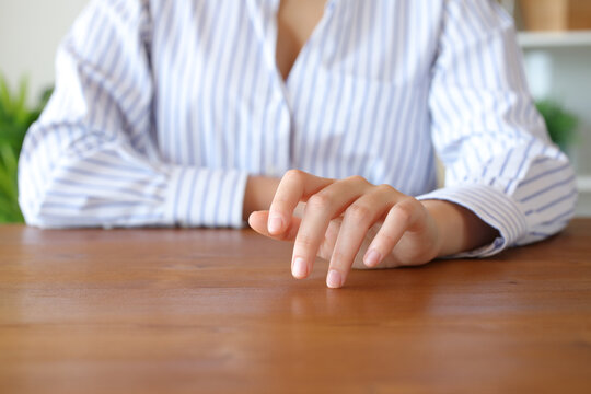Woman hand waiting and tapping fingers on table