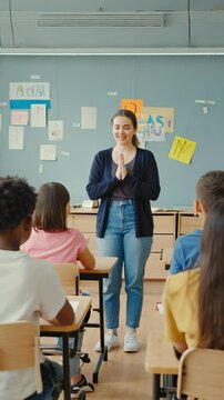 A teacher warmly interacts with a diverse group of students, guiding them in sign language while bright sunlight fills the classroom. ASL posters enhance the learning environment