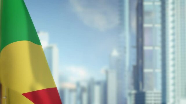 hanging Congo flag on city background with blue sky