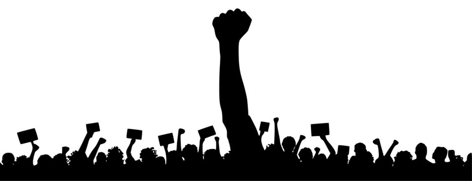 Silhouette of raised fist over crowd of protesters