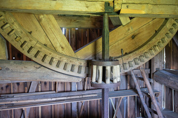 A wooden structure with a large wooden wheel inside