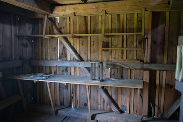 A small, empty room with a wooden shelf and a table