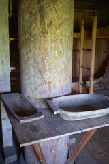 A wooden post with two wooden bowls on top of it