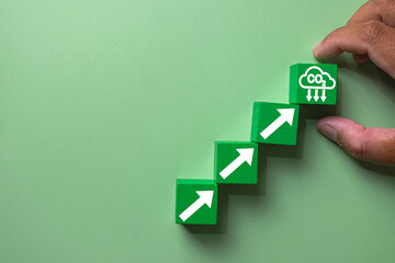 Hand arranging green blocks in steps with arrows leading to a CO2 reduction icon. Concept for carbon emission reduction strategy, decarbonization, climate change action,net-zero,carbon footprint.